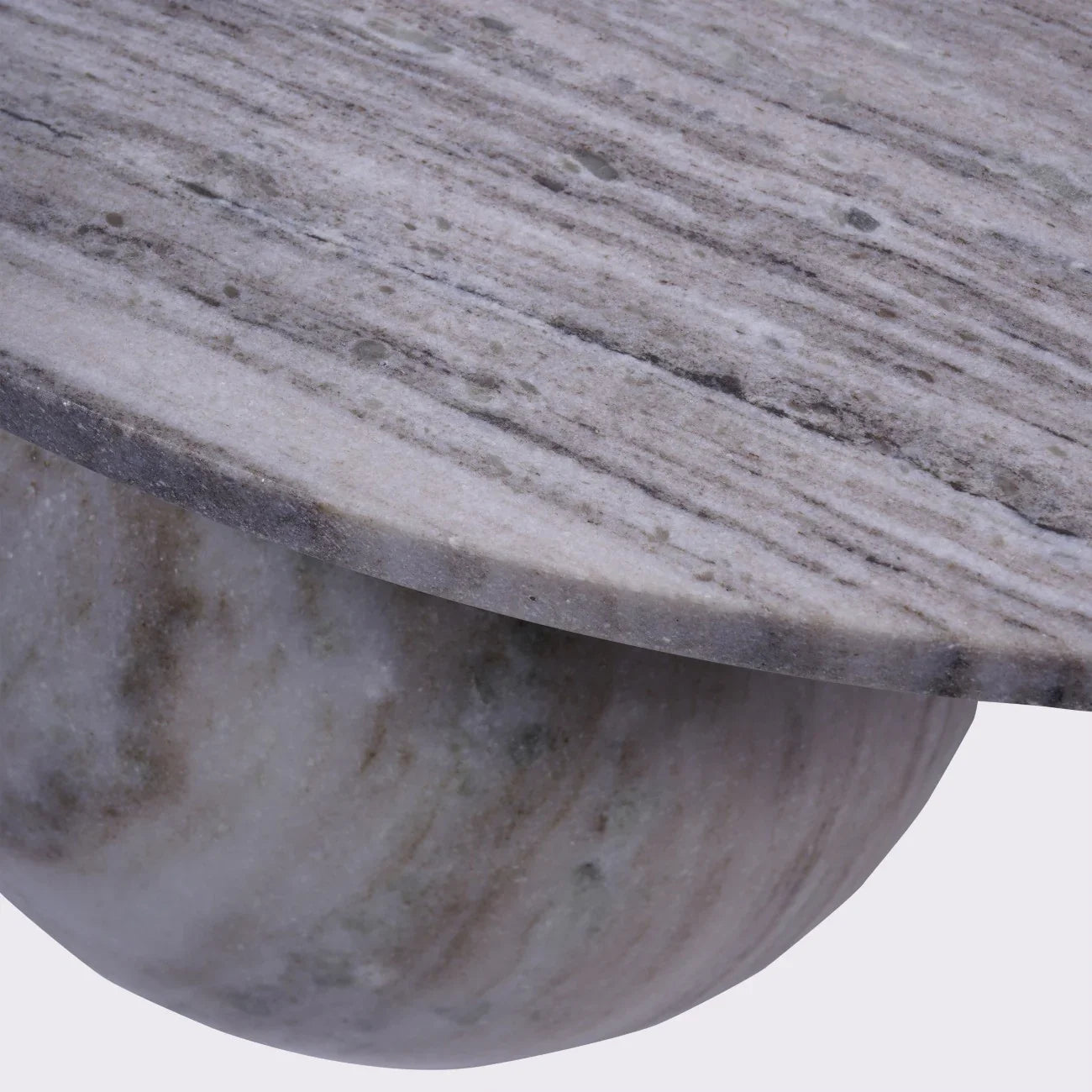 Grey marble coffee table edge with smooth, rounded base detail.