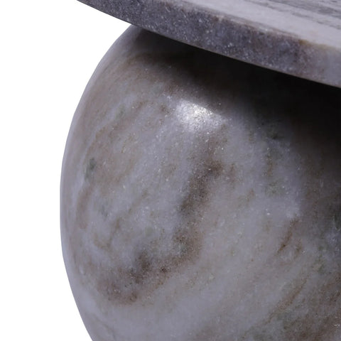 Close-up of marble coffee table leg with smooth, natural stone texture.