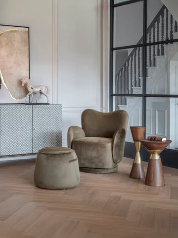 Wooden side table with gold accents in elegant living room setting.