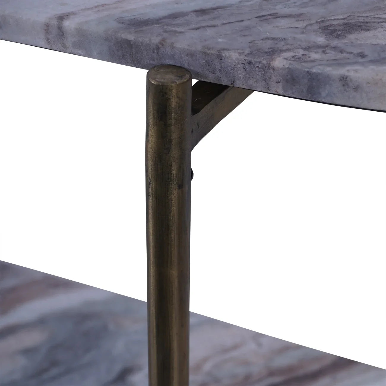 Close-up of grey marble table top with brass leg detail.