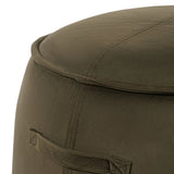 Close-up of green velvet stool with visible stitching detail.
