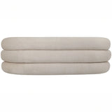 Cream sofa backrest with rounded, layered cushions.