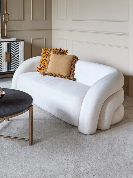 Cream two-seater sofa with mustard cushions in an elegant living room setting.