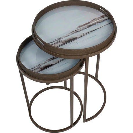 Brown nesting tray tables with blurred seascape design on top surfaces.