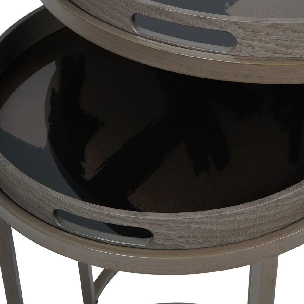 Taupe side tables with glossy black tray surfaces stacked together.