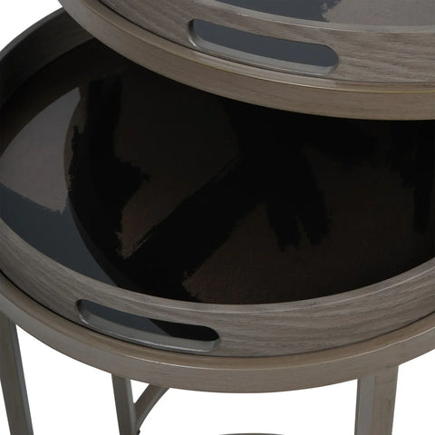 Taupe side tables with glossy black tray surfaces stacked together.