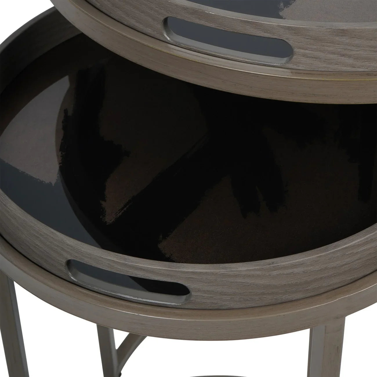 Taupe side tables with glossy black tray surfaces stacked together.