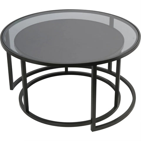 Black metal nesting tables with glass tops, one tucked under the other.