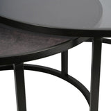 Black nesting tables with round metal frames and glass tops.