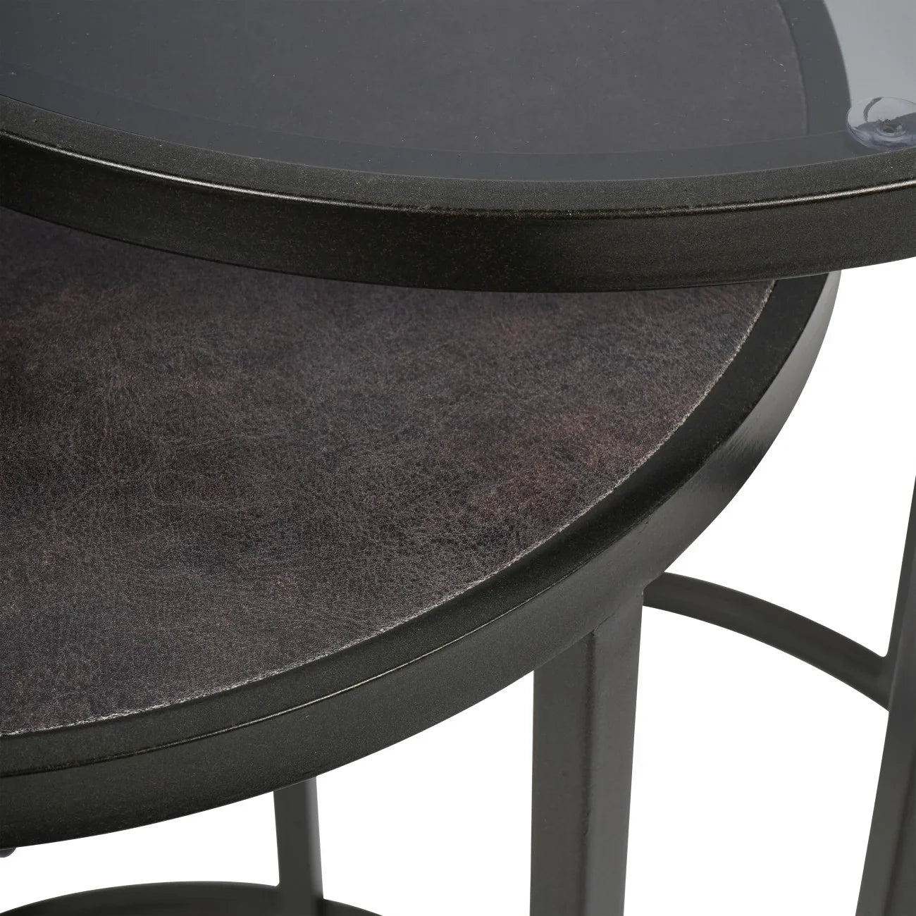 Dark nesting tables with glass and textured surfaces.