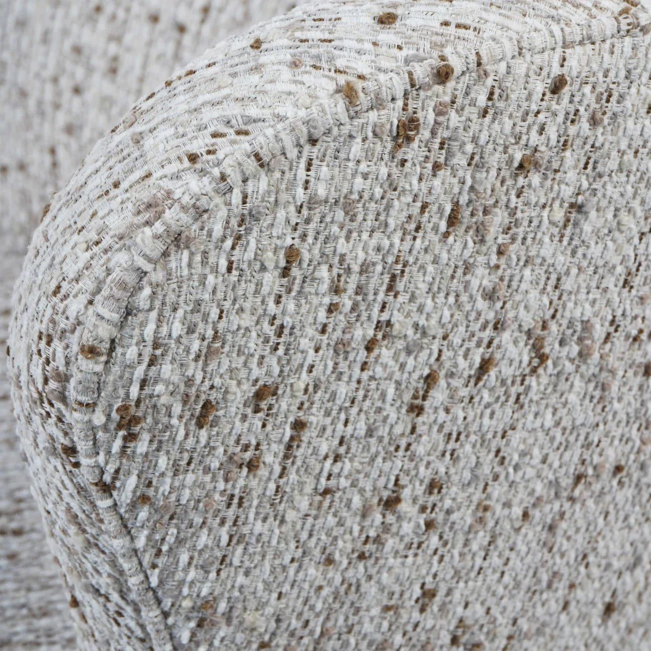 Natural slub fabric chair detail with textured weave and subtle brown speckles.