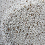 Natural slub fabric chair detail with textured weave and subtle brown speckles.