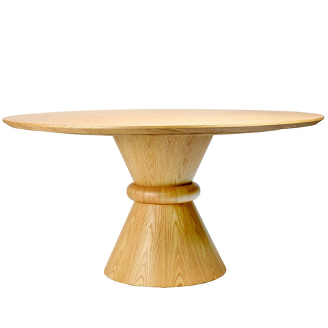 Light wood round dining table with a sculpted pedestal base.