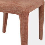 Brown upholstered chair leg with textured fabric detail.