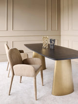 Wheat-toned upholstered chair beside a modern dining table in an elegant room.