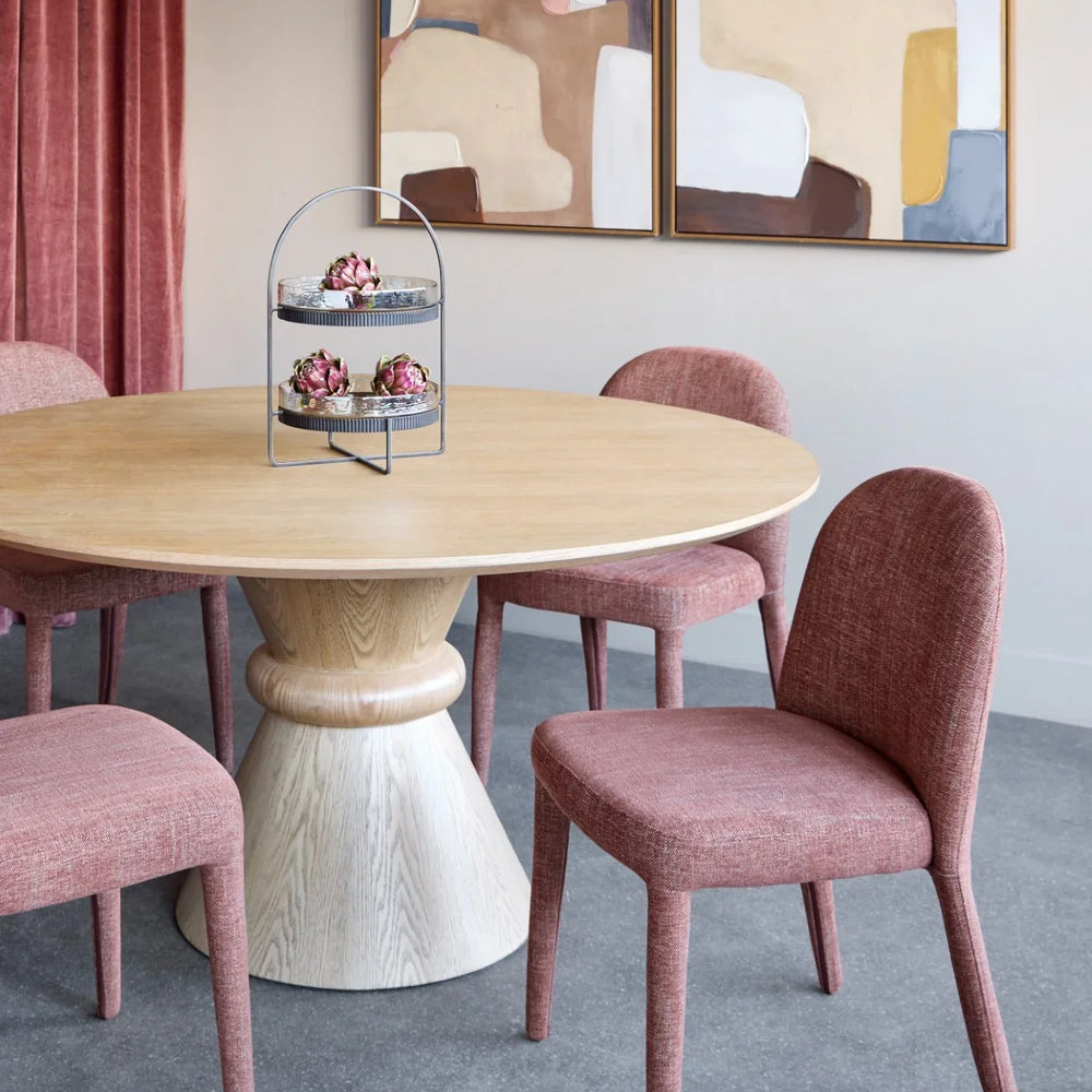 Red-brown upholstered dining chairs around a light wood table in a modern dining room.