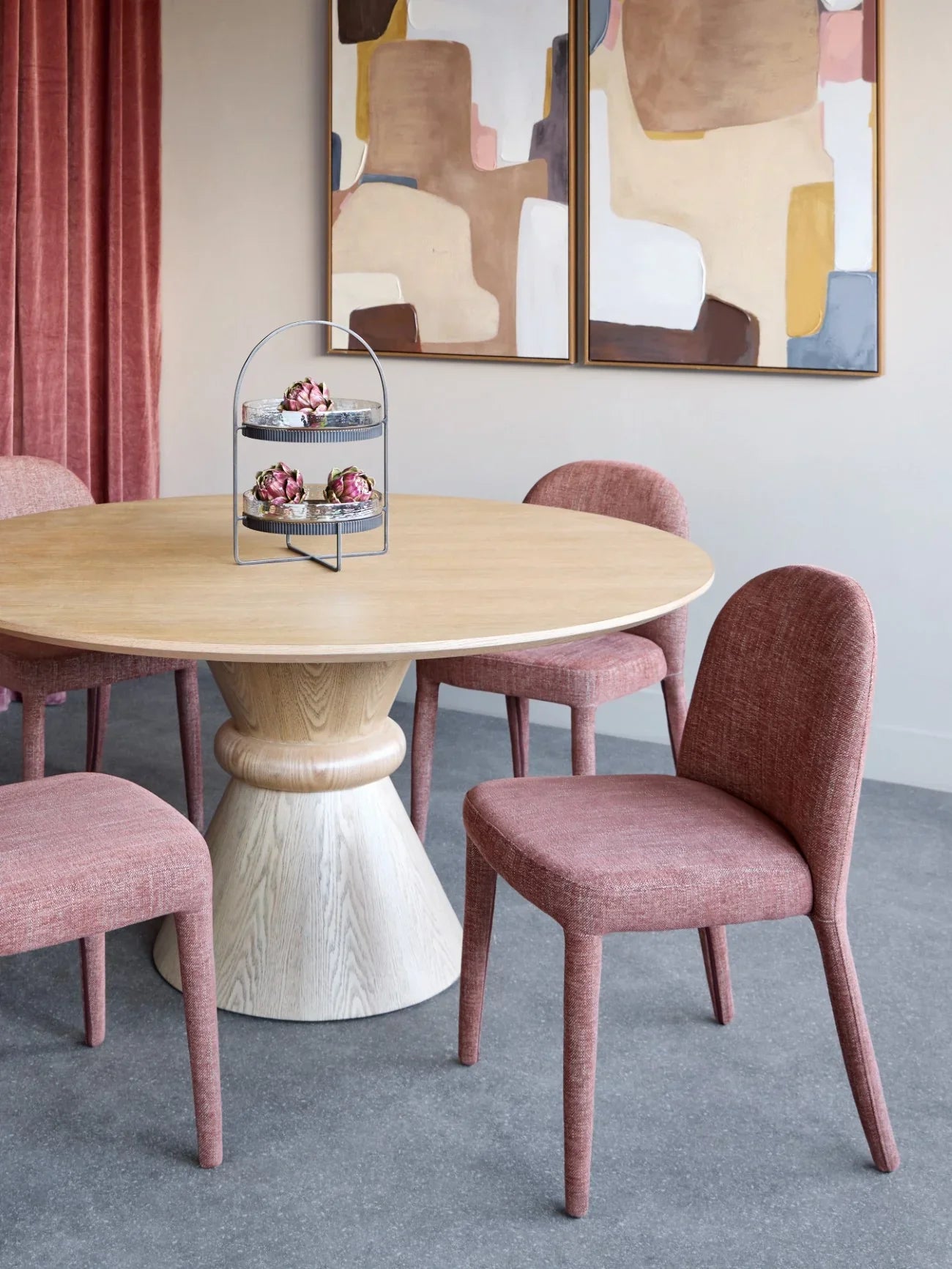 Red-brown upholstered dining chairs around a light wood table in a modern dining room.