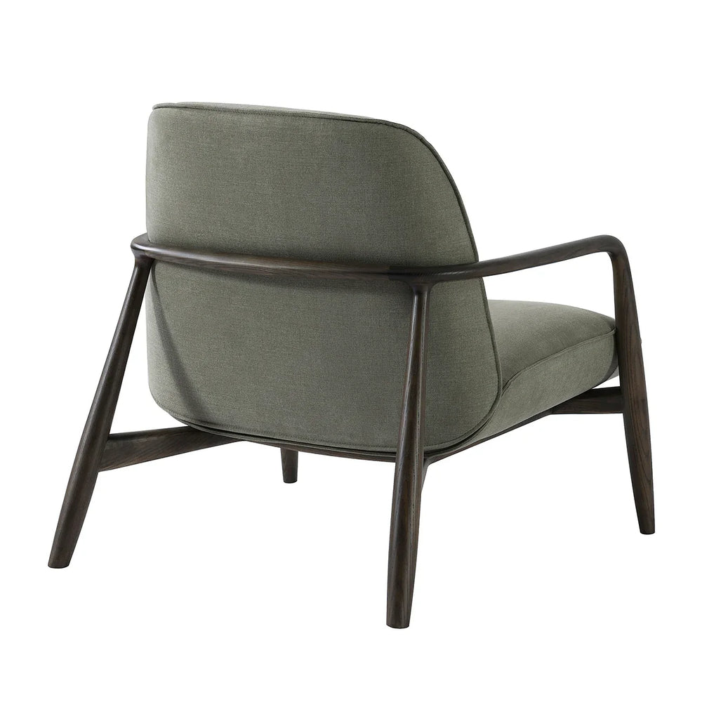 Green fabric chair with curved wooden arms, rear view.