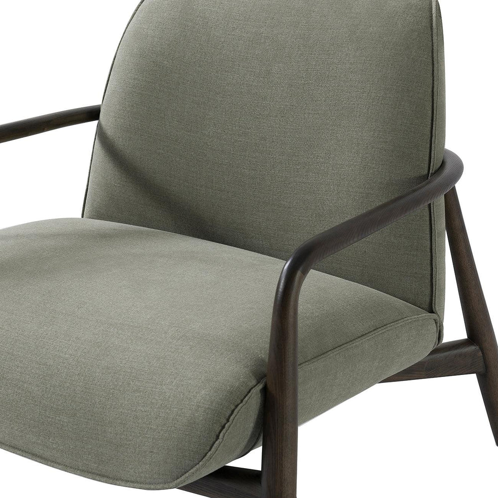 Green fabric chair with curved wooden arms and cushioned seat.