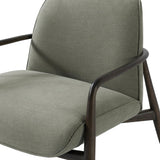 Green fabric chair with curved wooden arms and cushioned seat.