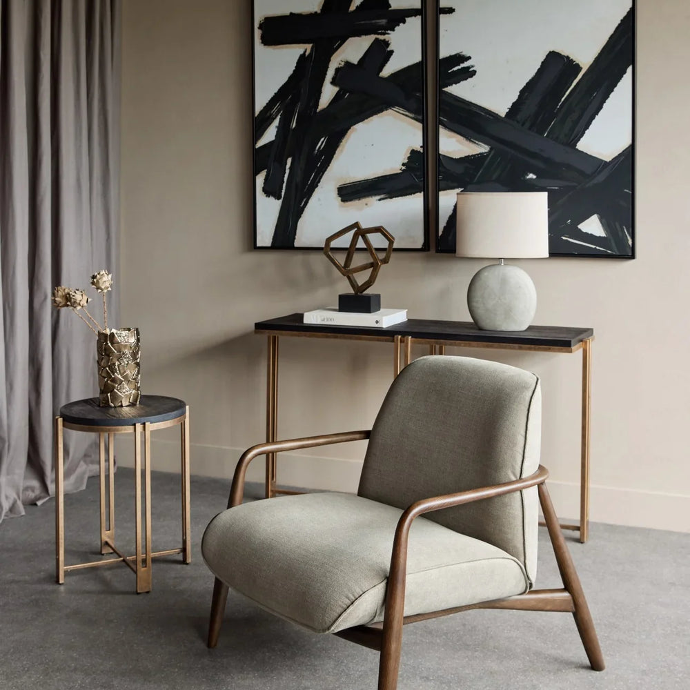 Green fabric chair with wooden arms in modern living room setting.