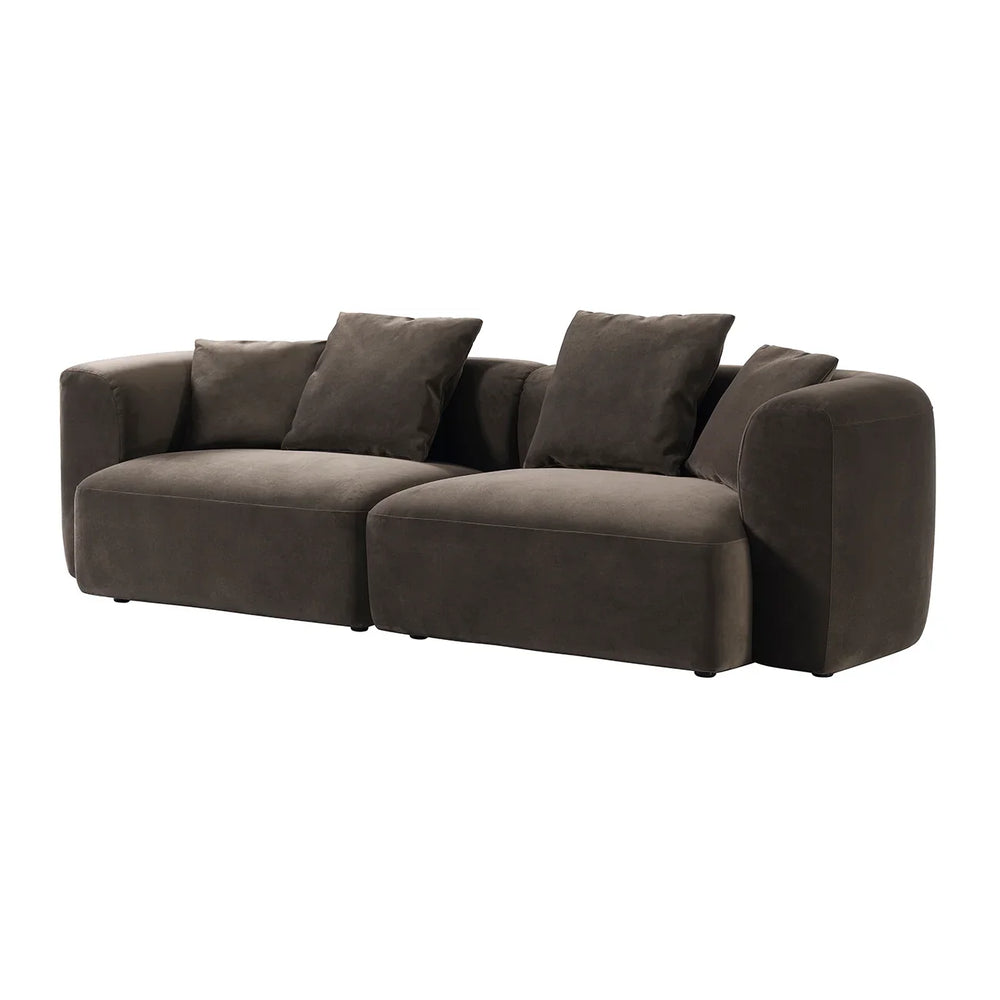 Brown velvet sofa with plush cushions and rounded arms.