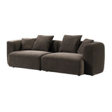 Brown velvet sofa with plush cushions and rounded arms.
