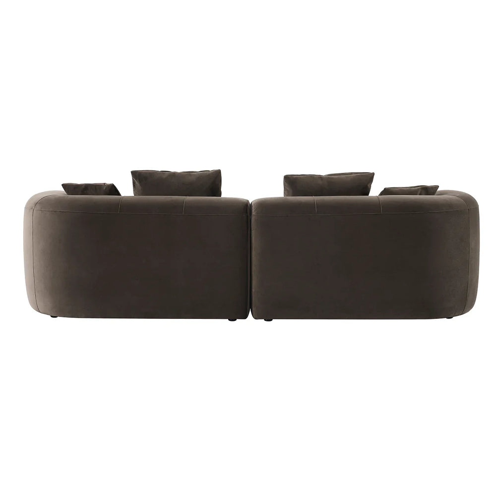 Back view of a brown velvet sofa with plush cushions.