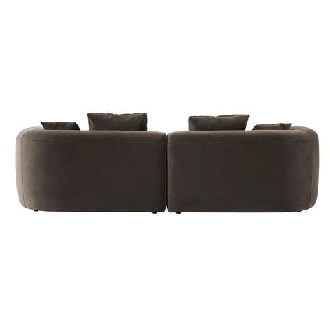 Back view of a brown velvet sofa with plush cushions.