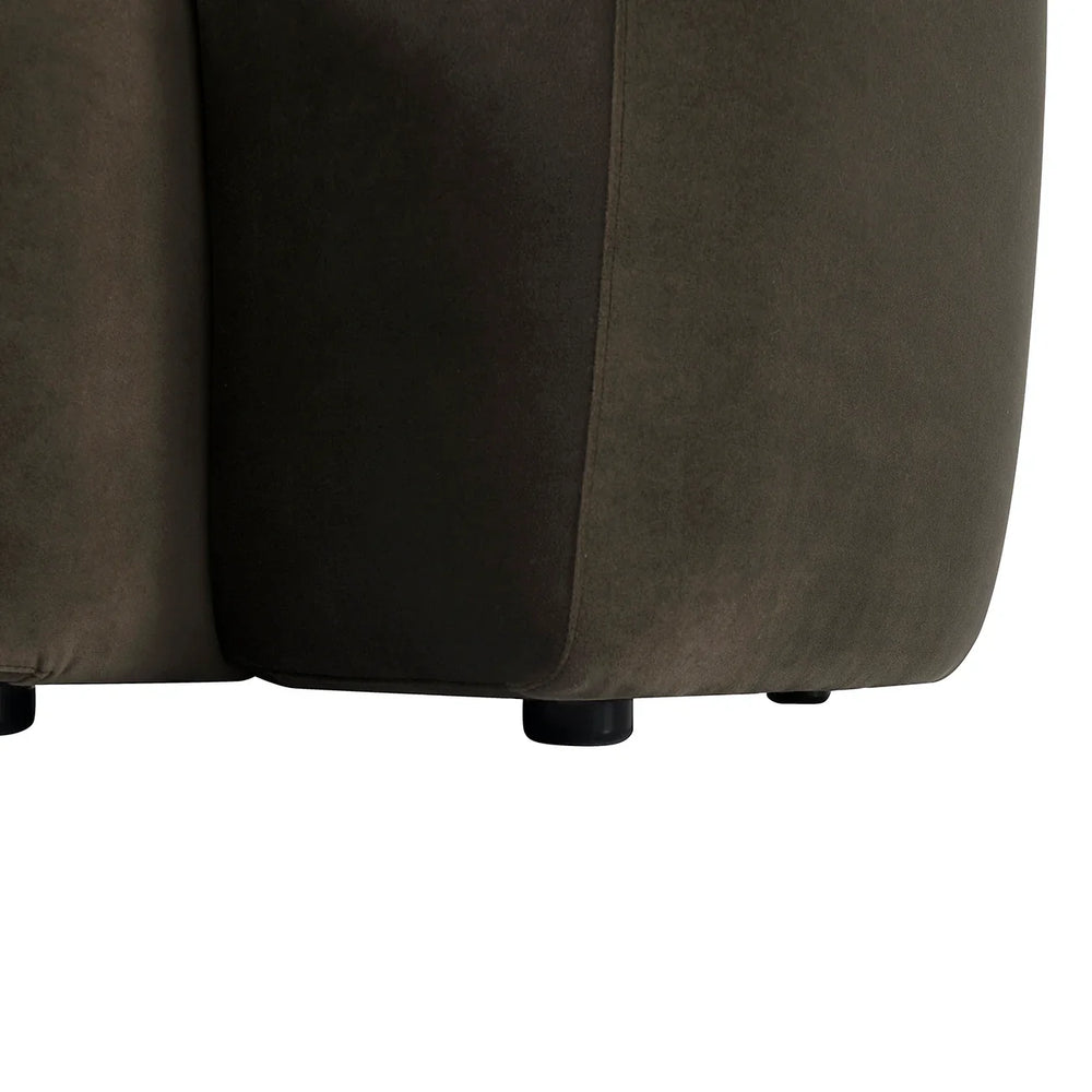 Brown velvet sofa base with black round legs.