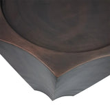Antique bronze plinth corner with smooth, curved edges and subtle texture.