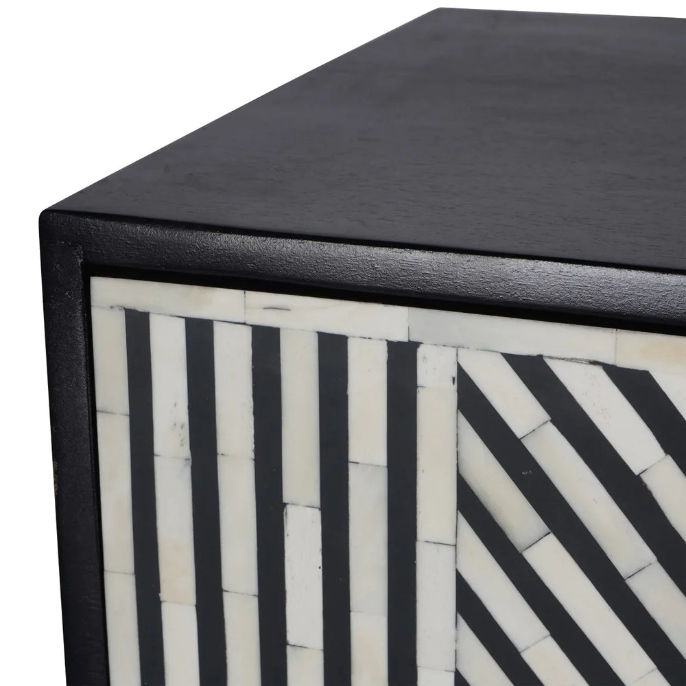 Black and white geometric pattern on cabinet corner detail.