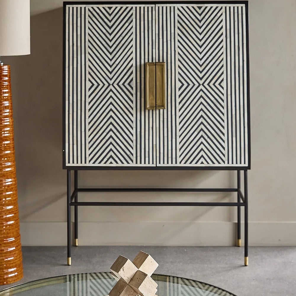 Geometric inlay cabinet in modern living room with glass coffee table.