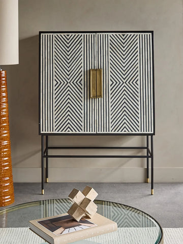 Geometric inlay cabinet in modern living room with glass coffee table.