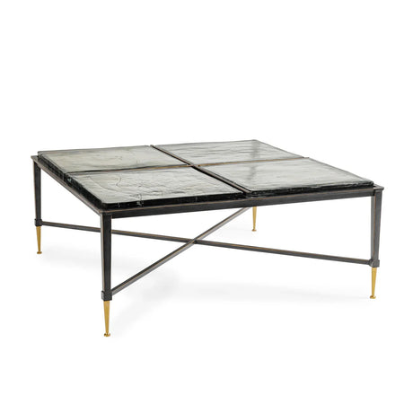Black metal coffee table with glass top and gold-tipped legs.