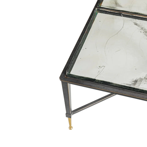 Glass tabletop with sleek metal frame and gold-tipped legs.