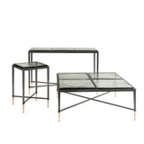 Set of three glass tables with black frames and gold-tipped legs.