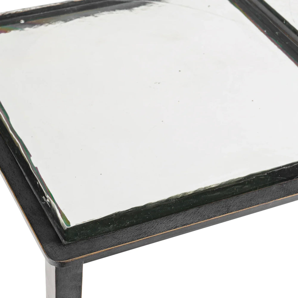 Clear glass tabletop with black metal edge detail.