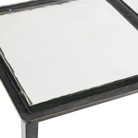 Clear glass tabletop with black metal edge detail.