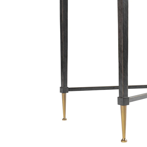 Black metal table legs with gold-tipped feet detail.