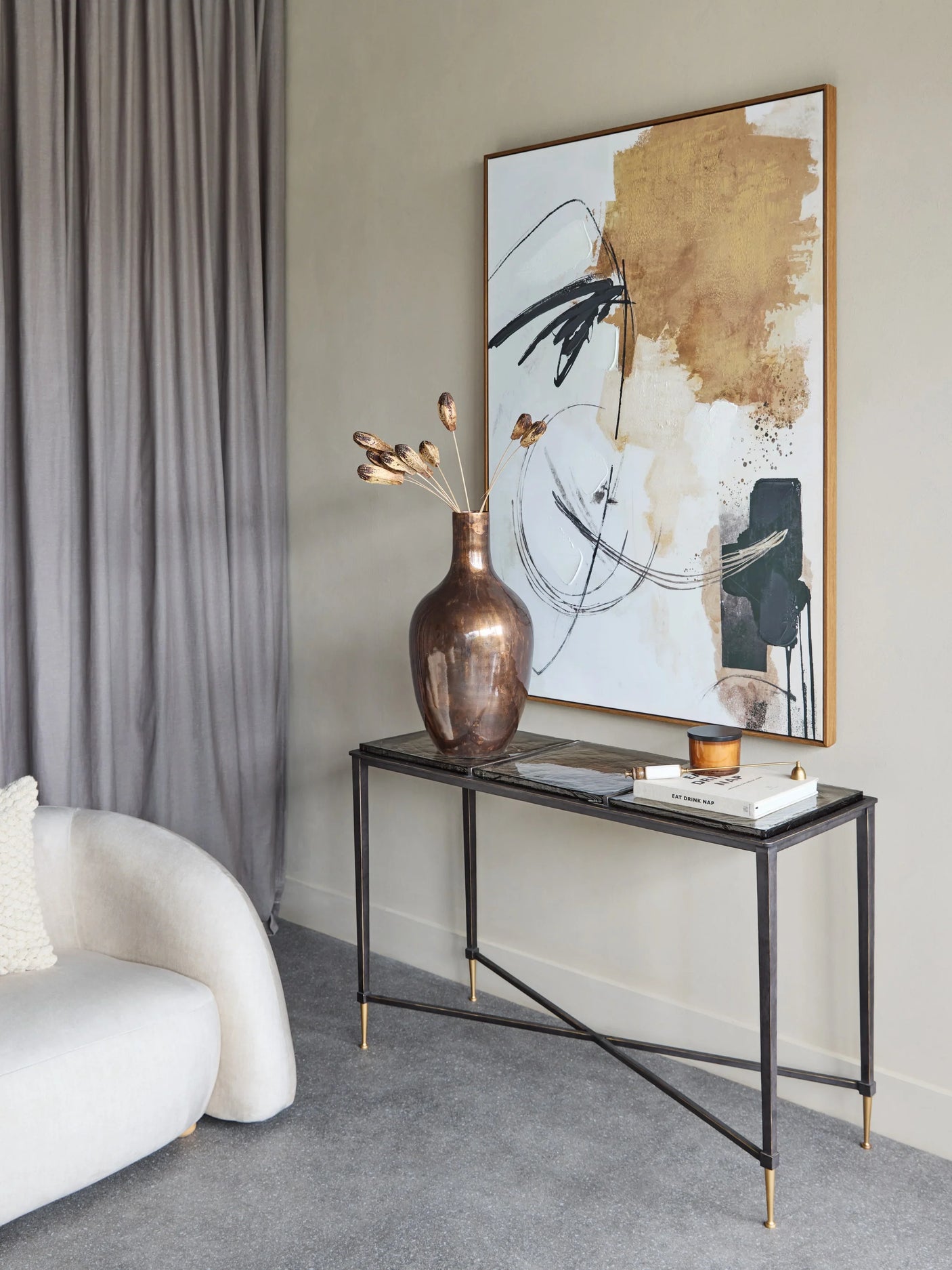 Glass console table with metal frame in modern living room setting.