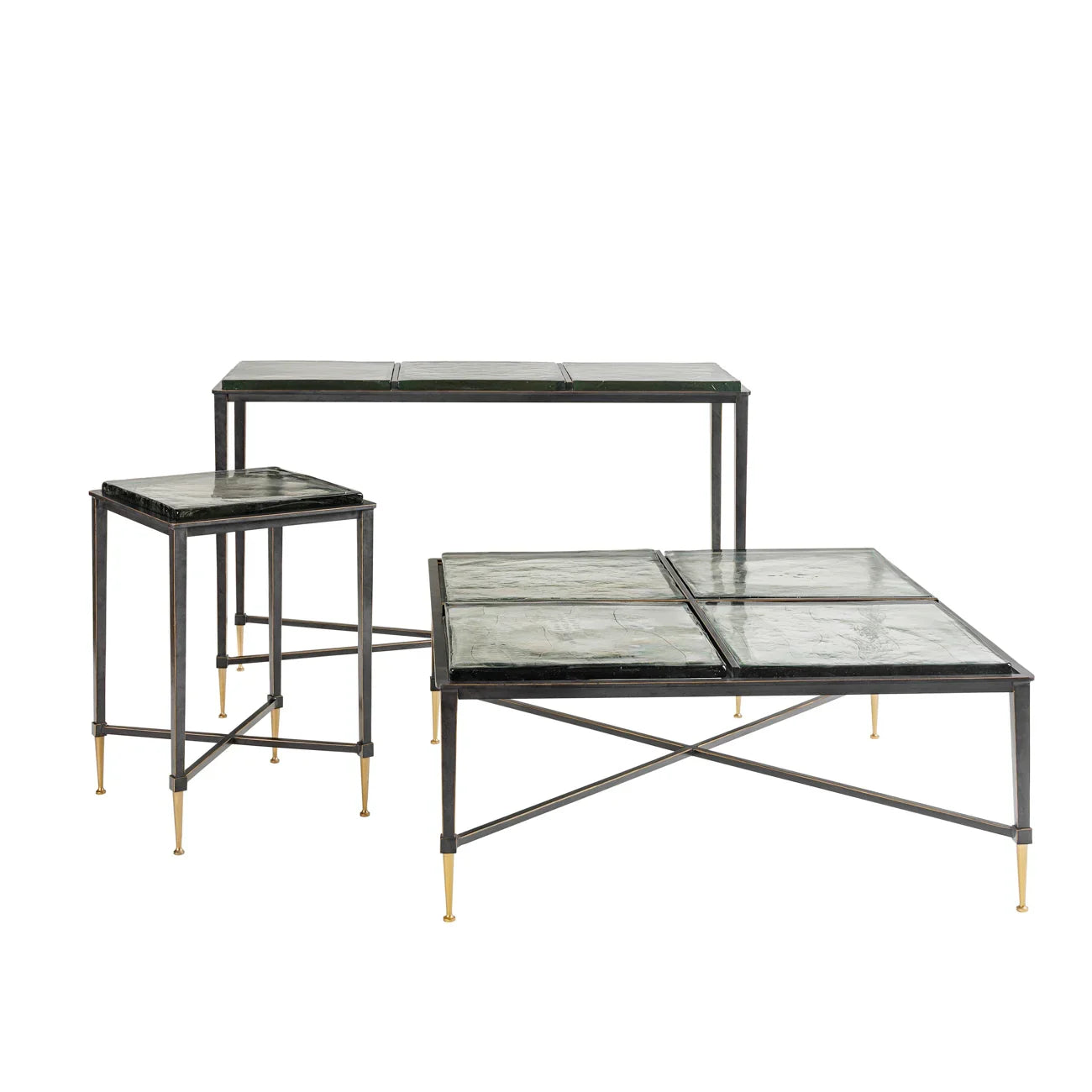 Set of glass tables with black frames and gold-tipped legs.
