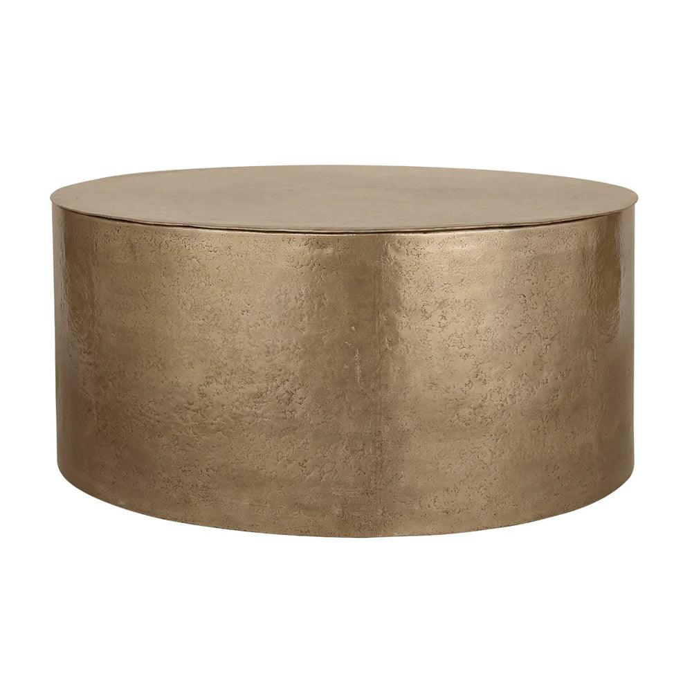 Gold metal drum coffee table with textured surface.
