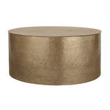 Gold metal drum coffee table with textured surface.