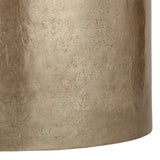 Gold metal surface with textured finish on a drum-shaped table.
