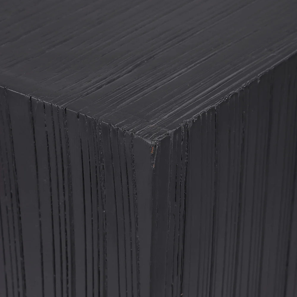 Dark wooden plinth showing layered texture detail.
