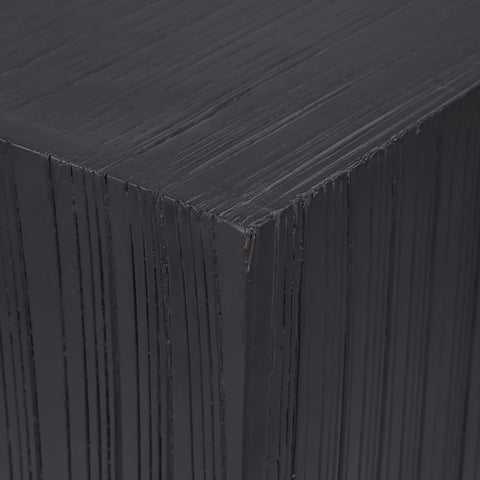 Dark wooden plinth showing layered texture detail.
