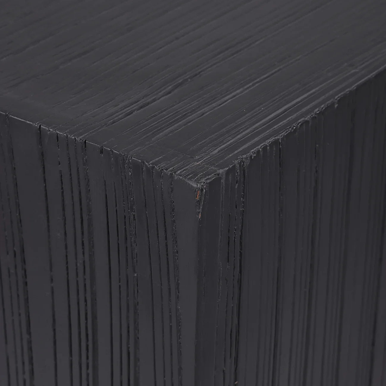 Dark wooden plinth showing layered texture detail.
