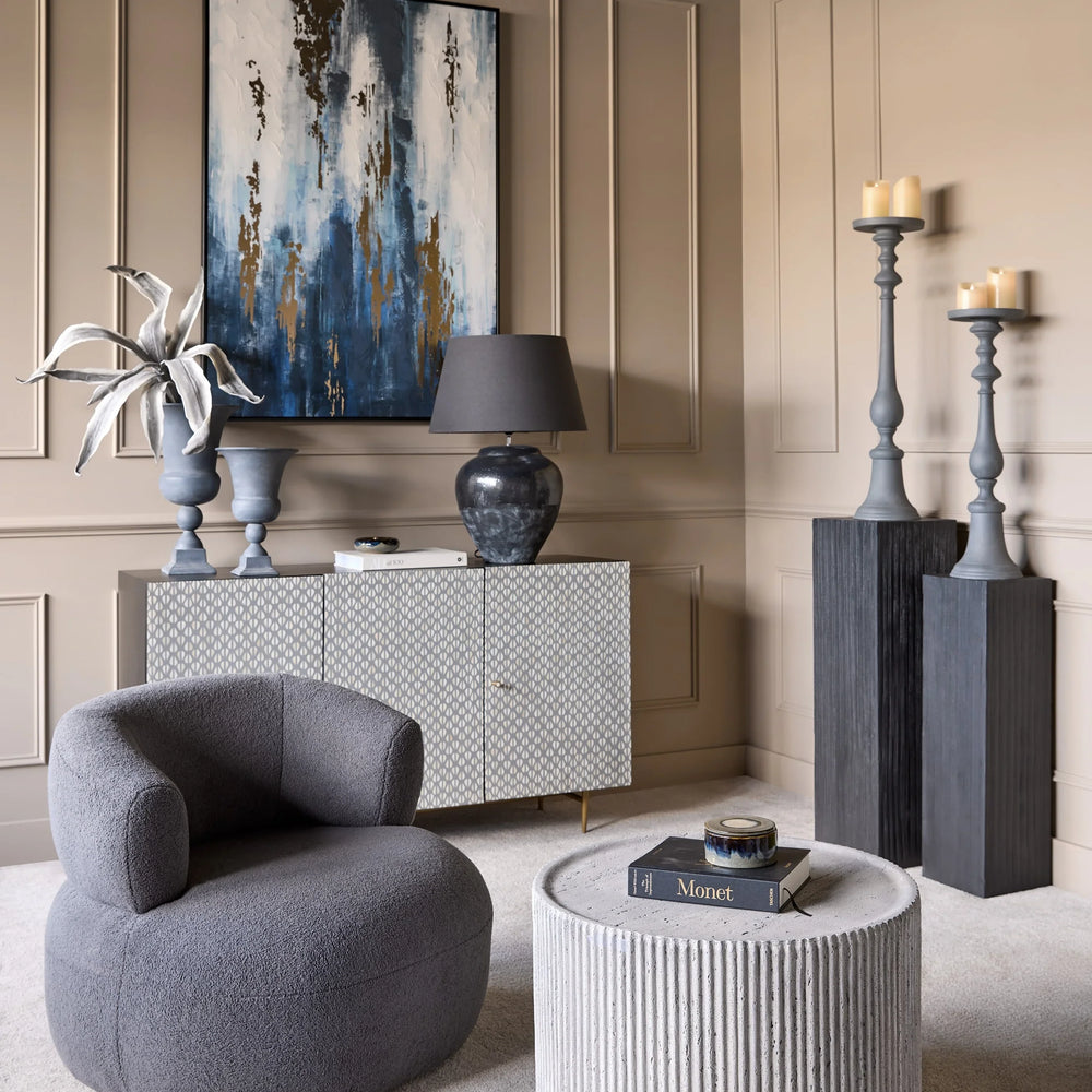 Grey wooden plinths in elegant living room with modern decor and artwork.