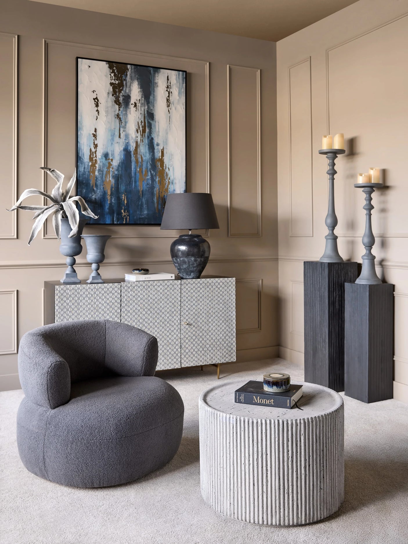 Grey wooden plinths in elegant living room with modern decor and artwork.